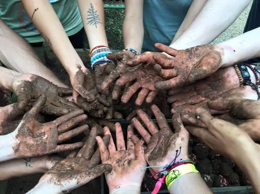 Hands at work in the garden at Rancho Delicioso